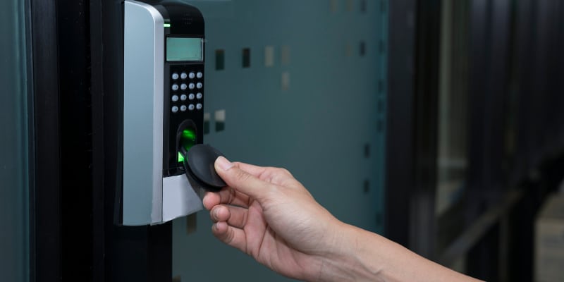 Young woman using RFID tag key to open the door.